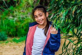 photo of a smiling girl in a blue jacket