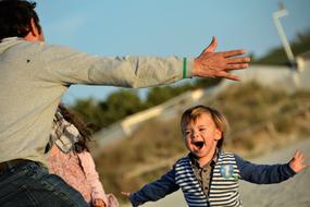 joyful dad and baby run towards each other