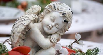 stone sculpture of a sad angel close up