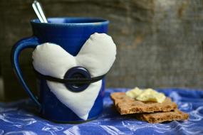 blue mug with white soft heart on side