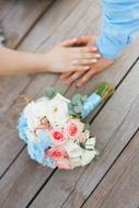 hands of lovers and a delicate bouquet of bride