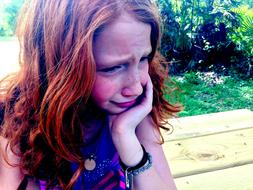 Crying Sad girl near the plants