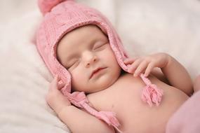 baby in a pink knitted hat