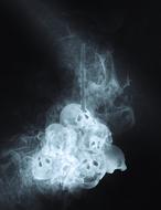 skulls in smoke on black background