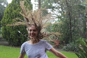 Happy young girl runs in Rain