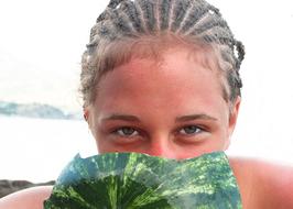 young tanned Girl with watermelon at face
