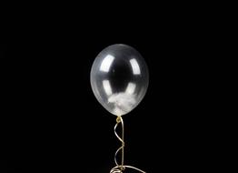 photo of a transparent balloon on a black wall background