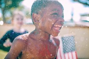 wet laughing black boy