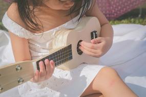 girl in a white dress with a guitar