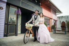 photo of newlyweds with a bicycle