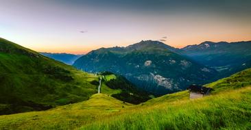 barn on a green mountainside in Austria