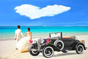 beautiful photo of newlyweds and retro car on a tropical beach