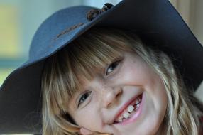 photo portrait of a smiling girl in a hat