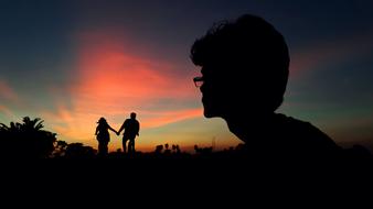 Alone man and Couple at the sunset