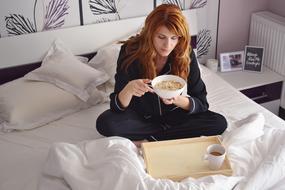girl having breakfast on the bed