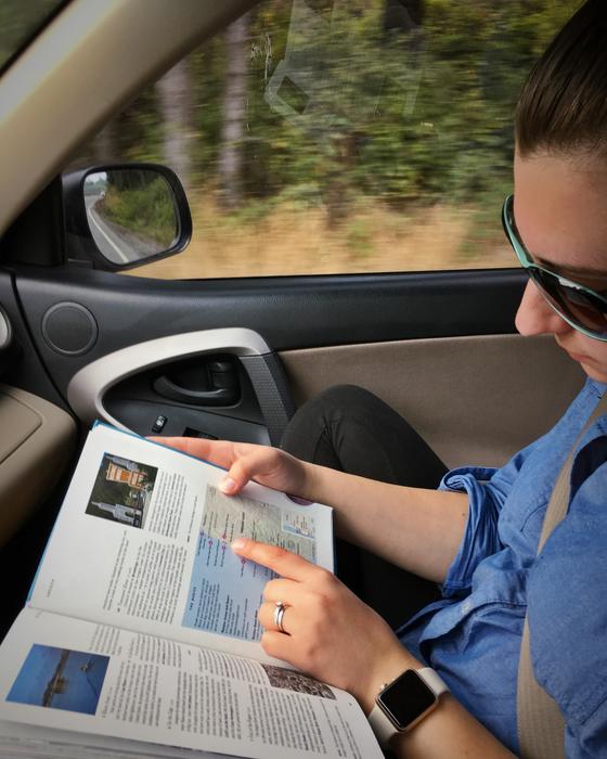 man examines the map in the car on a blurred background