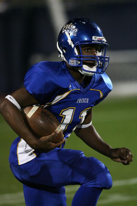 athlete in blue uniform with ball on blurred background