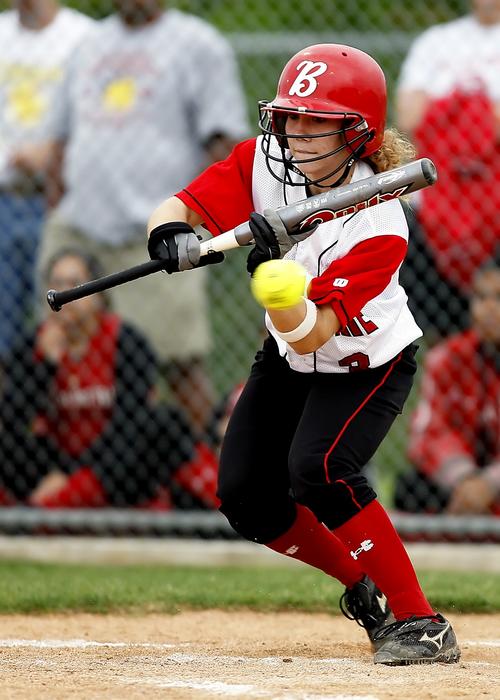 Softball girl player, in white and red uniform, with the bat, on the ...