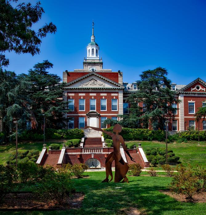 Beautiful and colorful Howard University, among the green trees in USA, at blue sky on background