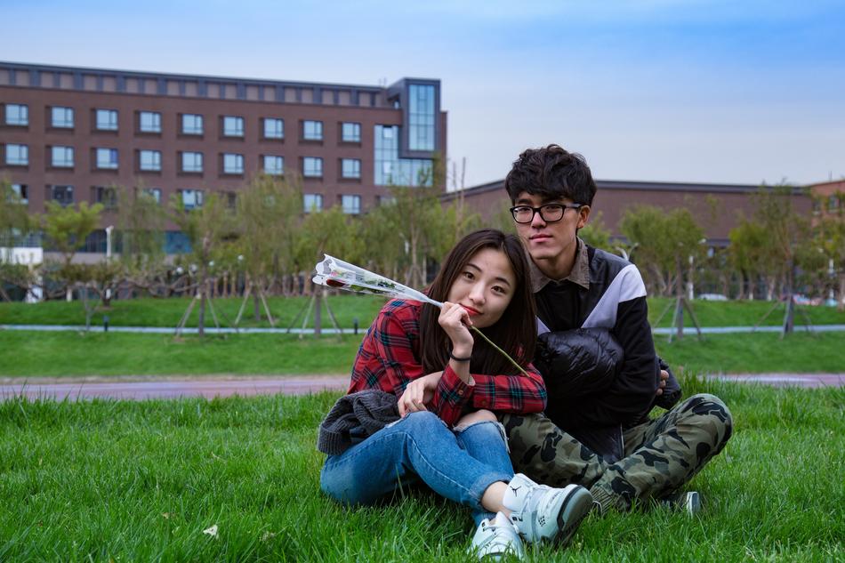 photo of asian schoolchildren in love on the lawn