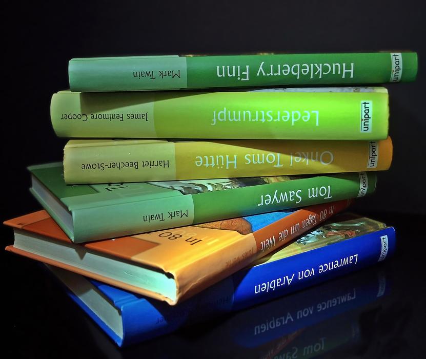 stack of classical literature on black background