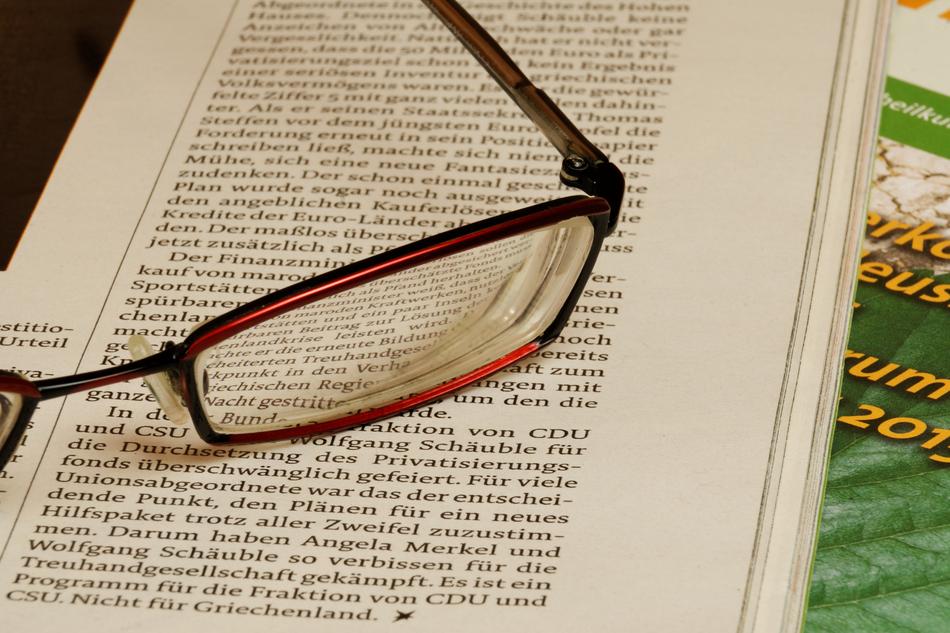 Red glasses on the open text