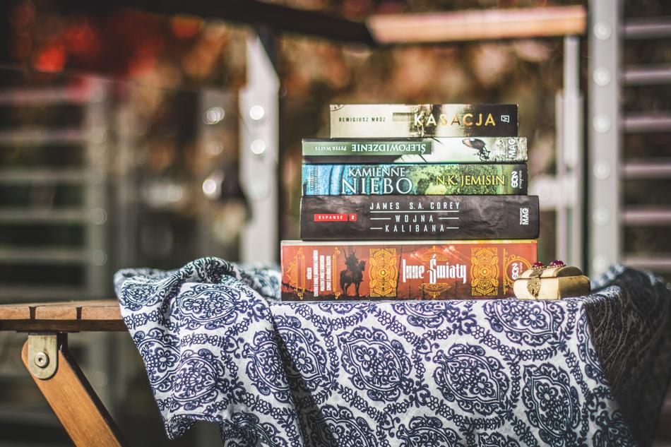 Colorful and beautiful books, on the blue and white, patterned cloth, on the wooden table