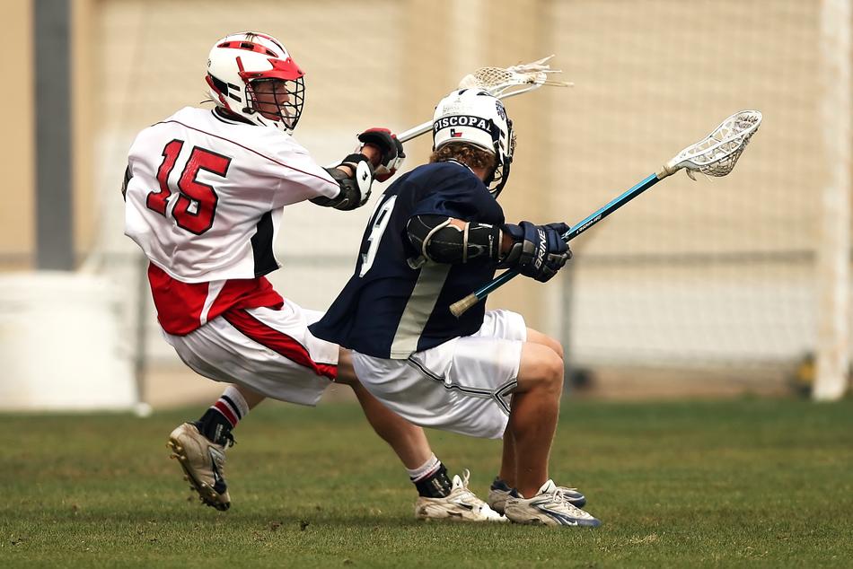 fight for the ball on the field in lacrosse