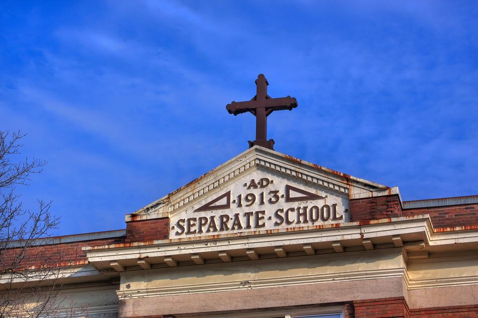 cross on the roof of the school in the evening