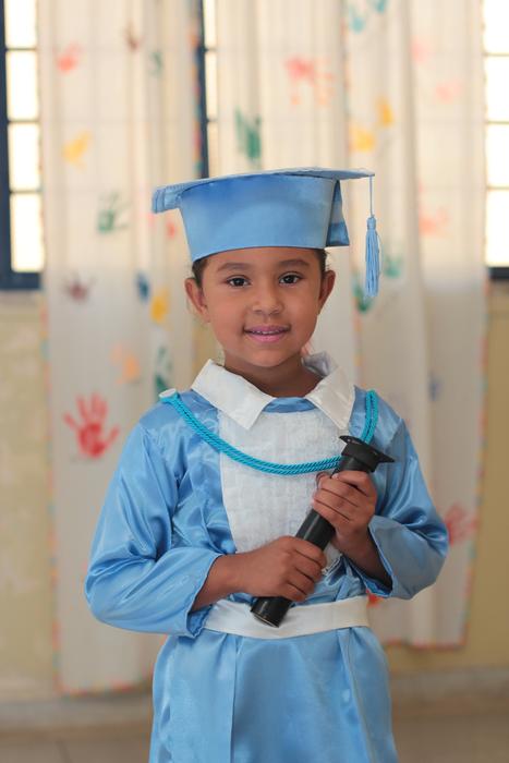 Schoolboy in blue and white clothing on graduation