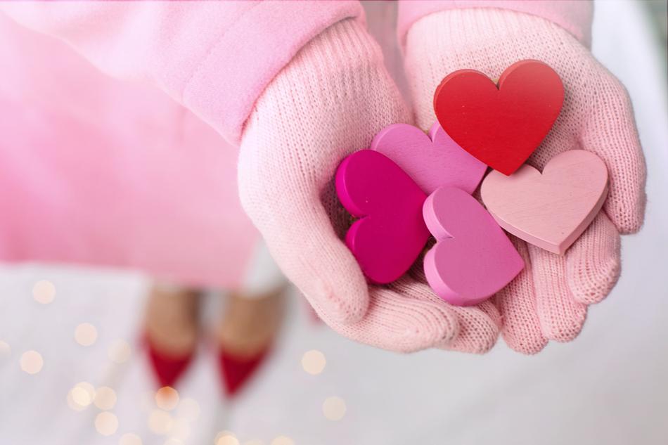 Valentineâs Day, five Hearts on female hands in gloves