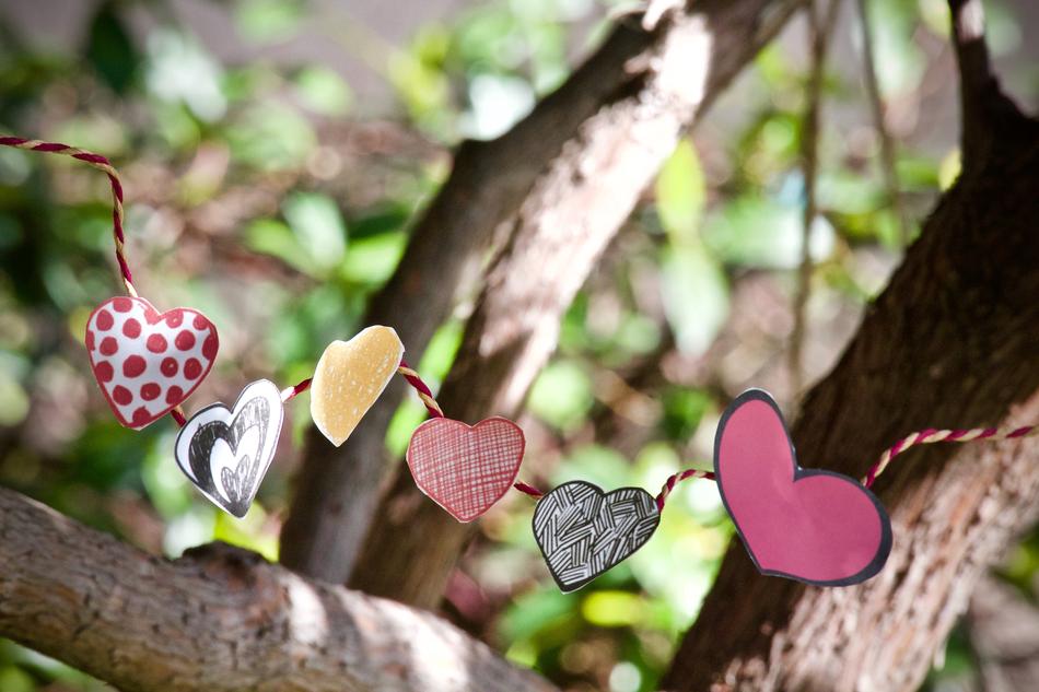 Beautiful and colorful hearts, on the tree, with the green leaves, in light
