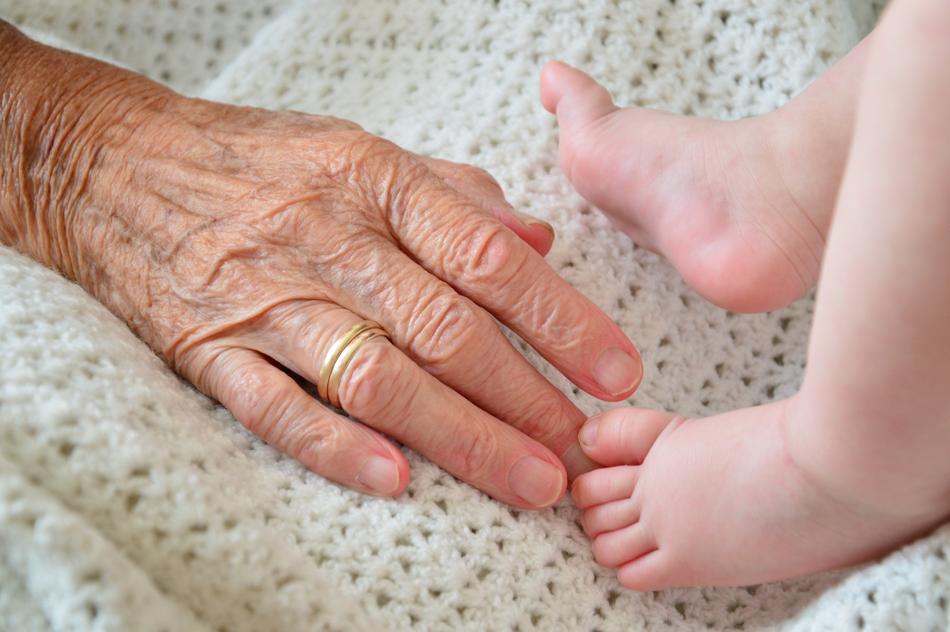 grandmother's hand and baby feet