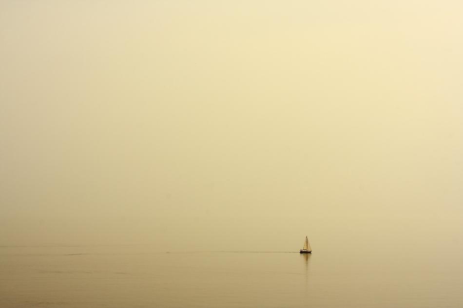 Boat in yellow haze on the beautiful waterscape