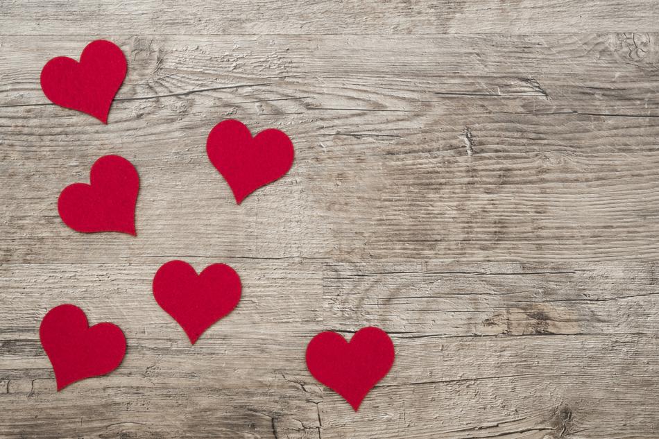 red hearts on wooden background as decoration