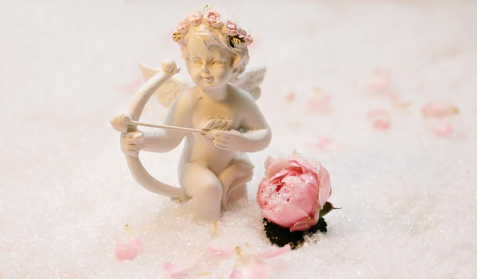 plaster sculpture of an angel and pink peony