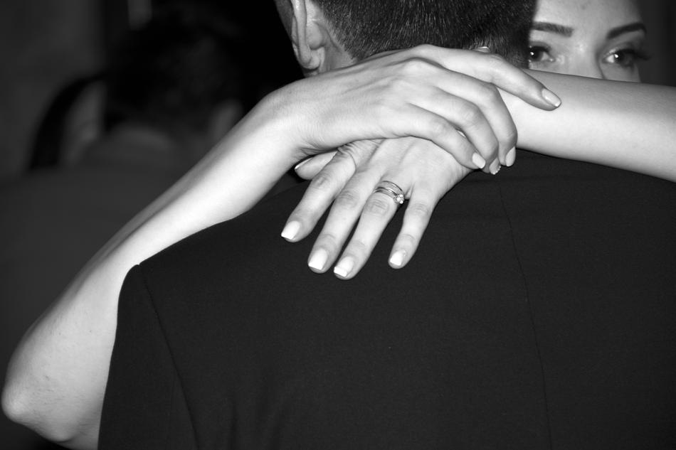 woman hands on man’s shoulders
