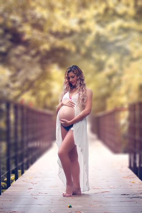 photo of a pregnant girl on the bridge