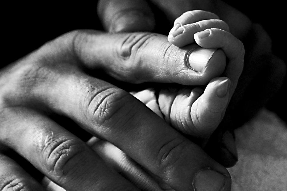 hands of baby and father