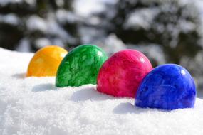 four Colorful Easter Eggs on snow