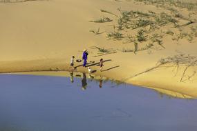 photo of a family on a beach by a lake in Vietnam