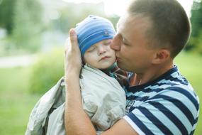father kisses son