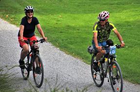 happy young boy and girl riding bicycles in park