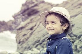 curly Child boy in white hat outdoor