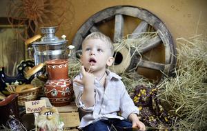 photo of a boy on the background of rural utensils