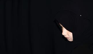 photo of a sad girl in a black shawl