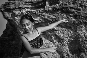 black and white photo of a girl dancing on a background of mountains