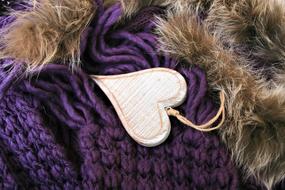 white wood heart on a purple scarf