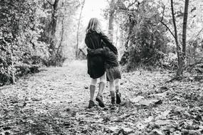happy siblings in the park in black and white background