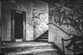 graffiti on the walls of a dilapidated building in black and white background